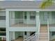 Charming condo exterior showcasing the building number and a well-maintained facade with easy access stairway at 5725 Greenwood Ave # 8203, North Port, FL 34287