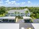 Exterior view of a multi-Gathering home with parking spaces and tropical landscaping at 5725 Greenwood Ave # 8203, North Port, FL 34287