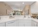 Bright kitchen with white cabinetry, modern appliances, and a breakfast bar overlooking the living area at 5725 Greenwood Ave # 8203, North Port, FL 34287
