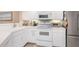 Modern kitchen with stainless steel appliances and white cabinets for a clean and efficient cooking space at 5725 Greenwood Ave # 8203, North Port, FL 34287