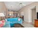 Open-concept living area with blue sofas, rattan coffee table, and views of the dining area and other rooms at 5725 Greenwood Ave # 8203, North Port, FL 34287
