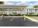 Convenient covered parking area with easy access to condo buildings and well-maintained landscaping at 5725 Greenwood Ave # 8203, North Port, FL 34287