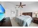 Spacious bedroom with a ceiling fan, TV, and a king-size bed for ultimate comfort at 5762 Sabal Trace Dr # 203, North Port, FL 34287