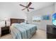 Relaxing bedroom featuring a king-size bed, ceiling fan, and a window with a view at 5762 Sabal Trace Dr # 203, North Port, FL 34287