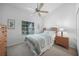 Cozy bedroom with a ceiling fan, dresser, and window that lets in natural light at 5762 Sabal Trace Dr # 203, North Port, FL 34287