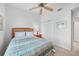 Cozy bedroom features neutral decor, ceiling fan, and closet at 5762 Sabal Trace Dr # 203, North Port, FL 34287