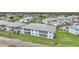 Bright, two-story condo building with covered patios, well-maintained landscaping, and a serene pond view at 5762 Sabal Trace Dr # 203, North Port, FL 34287