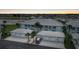 Two-story condo building with garage parking, well-maintained landscaping, and neighborhood views at dusk at 5762 Sabal Trace Dr # 203, North Port, FL 34287
