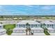 Two-story condo building with garage parking, well-maintained landscaping, and open, neighborhood views at 5762 Sabal Trace Dr # 203, North Port, FL 34287