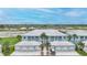 Charming blue condo with a metal roof, garages, and lush landscaping at 5762 Sabal Trace Dr # 203, North Port, FL 34287