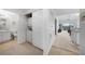 Hallway with laundry closet leads to the bathroom and living area at 5762 Sabal Trace Dr # 203, North Port, FL 34287
