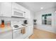 Bright kitchen with stainless steel sink, stove, and overhead microwave at 5762 Sabal Trace Dr # 203, North Port, FL 34287