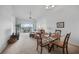 Bright living and dining area with vaulted ceilings and a sliding glass door to the screened balcony at 5762 Sabal Trace Dr # 203, North Port, FL 34287