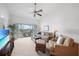 Comfortable living room with plush seating and access to a screened balcony with a view at 5762 Sabal Trace Dr # 203, North Port, FL 34287