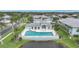 Community pool with comfortable seating, well-maintained landscaping and a serene pond view at 5762 Sabal Trace Dr # 203, North Port, FL 34287