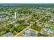 Residential neighborhood with mature landscaping and well-maintained homes with tile roofs at 7183 Spinnaker Blvd, Englewood, FL 34224