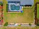 Drone shot of a home's pool and backyard area with lush green grass at 7183 Spinnaker Blvd, Englewood, FL 34224