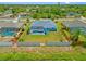 Expansive aerial view of property featuring fenced yard, pool and mature landscaping at 7183 Spinnaker Blvd, Englewood, FL 34224