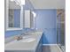 Well-lit bathroom with double sinks and a walk-in shower at 7183 Spinnaker Blvd, Englewood, FL 34224