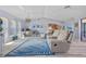 Spacious living room with vaulted ceilings, modern flooring, and comfortable seating at 7183 Spinnaker Blvd, Englewood, FL 34224