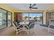Inviting screened-in porch with stylish furniture, ceiling fan, and views of the pool at 7183 Spinnaker Blvd, Englewood, FL 34224