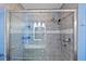 Elegant walk-in shower with glass door and tiled walls at 7183 Spinnaker Blvd, Englewood, FL 34224