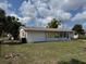 Rear view of property showcasing a sunroom and a spacious backyard perfect for outdoor activities at 8158 Trionfo Ave, North Port, FL 34287