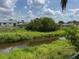 Scenic backyard with grassy area and a tranquil canal view at 8158 Trionfo Ave, North Port, FL 34287