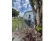 Fenced area with a utility setup including air conditioning units and a service gate at 8158 Trionfo Ave, North Port, FL 34287