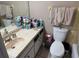 Bathroom with a toilet, sink, mirror, and towels at 8158 Trionfo Ave, North Port, FL 34287