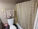 Bathroom with a toilet, shower curtain, and towels at 8158 Trionfo Ave, North Port, FL 34287