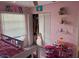 Bedroom with a closet, bed, and pink walls at 8158 Trionfo Ave, North Port, FL 34287