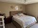 Bright bedroom with a large bed, ceiling fan, and decorative wall art at 8158 Trionfo Ave, North Port, FL 34287