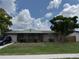Charming one-story home featuring a screened entrance, attached garage, and a well-manicured front yard at 8158 Trionfo Ave, North Port, FL 34287