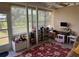 Bright living room with ample windows and a red patterned rug at 8158 Trionfo Ave, North Port, FL 34287