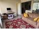 Cozy living room featuring a comfortable sofa and a patterned rug at 8158 Trionfo Ave, North Port, FL 34287