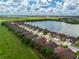 Aerial shot of a home in a lakeside community, highlighting its proximity to water and green fields at 8866 Tuscany Isles Dr, Punta Gorda, FL 33950