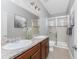 Bathroom features a double sink vanity, granite countertop, and a glass-enclosed shower at 8866 Tuscany Isles Dr, Punta Gorda, FL 33950