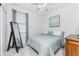 Cozy bedroom with a standing mirror, simple decor, and natural light from the window at 8866 Tuscany Isles Dr, Punta Gorda, FL 33950