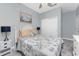 Bright bedroom featuring a bed with decorative pillows, a window, and simple décor at 8866 Tuscany Isles Dr, Punta Gorda, FL 33950