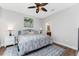 Well-lit bedroom with stylish decor including a rug, artwork, and matching nightstands at 8866 Tuscany Isles Dr, Punta Gorda, FL 33950
