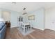 Bright dining room features light blue walls, wood floors, white furniture, modern light fixture and decor at 8866 Tuscany Isles Dr, Punta Gorda, FL 33950