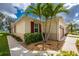 Well-maintained home exterior with lush landscaping, a two-tone paint scheme and charming decorative shutters at 8866 Tuscany Isles Dr, Punta Gorda, FL 33950
