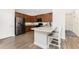 Modern kitchen features granite countertops, wood cabinets, stainless appliances, and a breakfast bar with seating at 8866 Tuscany Isles Dr, Punta Gorda, FL 33950