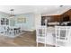This open kitchen/dining area features stainless steel appliances, brown cabinets, and granite countertops at 8866 Tuscany Isles Dr, Punta Gorda, FL 33950