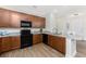 Stylish kitchen with stainless appliances, granite countertops, wood cabinets, and plenty of workspace at 8866 Tuscany Isles Dr, Punta Gorda, FL 33950