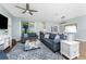 Cozy living room features a ceiling fan, and sliding glass doors that let in natural light at 8866 Tuscany Isles Dr, Punta Gorda, FL 33950