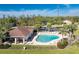 Community pool area featuring a modern pool with sun loungers, a covered patio, and ample seating at 8866 Tuscany Isles Dr, Punta Gorda, FL 33950