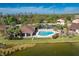 Relaxing community pool surrounded by palm trees and lush greenery, offering a refreshing oasis at 8866 Tuscany Isles Dr, Punta Gorda, FL 33950