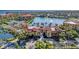 Beautiful aerial view of the condo community, highlighting a large fountain, lake, and manicured landscaping at 96 Vivante Blvd # 9622, Punta Gorda, FL 33950